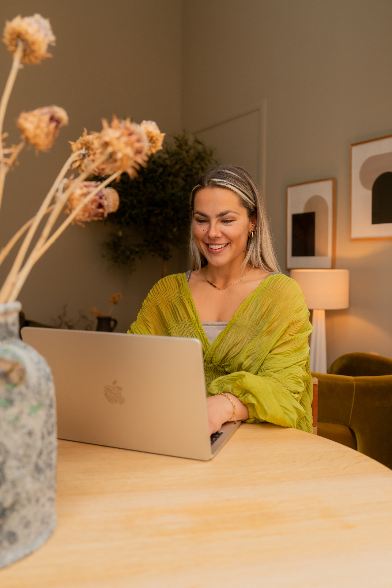 Gaya working at her laptop, ready to welcome you